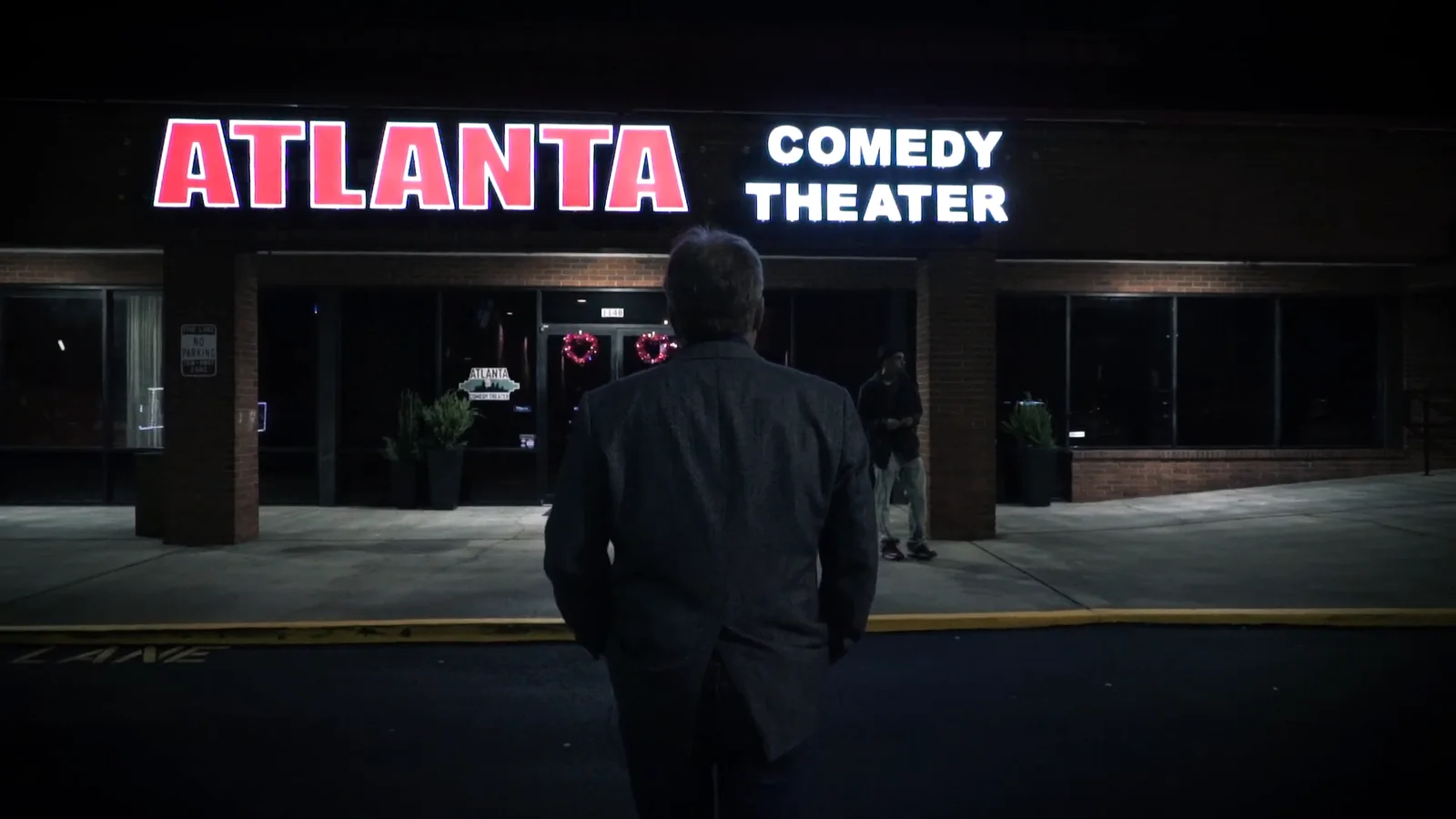 Greg Langford walking into the Atlanta Comedy Theater at night