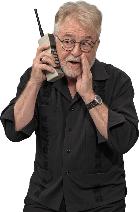 Uncle G on a giant retro cellphone, whispering a deal