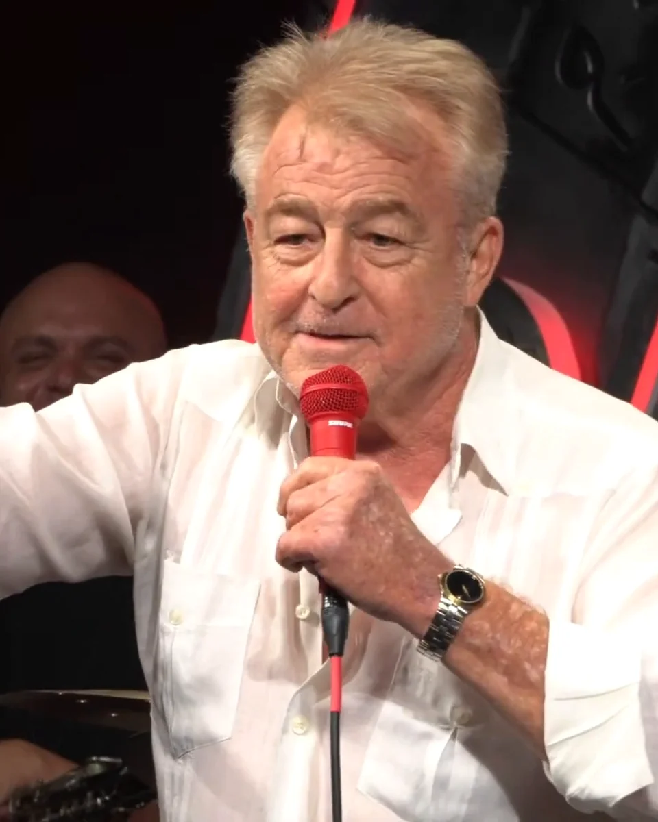 Uncle G in a white shirt pointing at the crowd