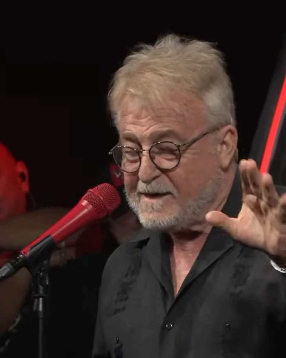 Uncle G close-up mid-story with a red microphone