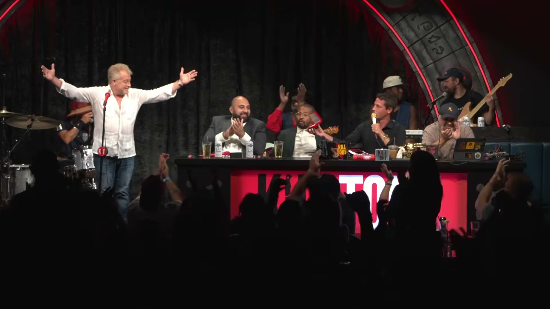 Uncle G raises his Golden Ticket on the Kill Tony stage